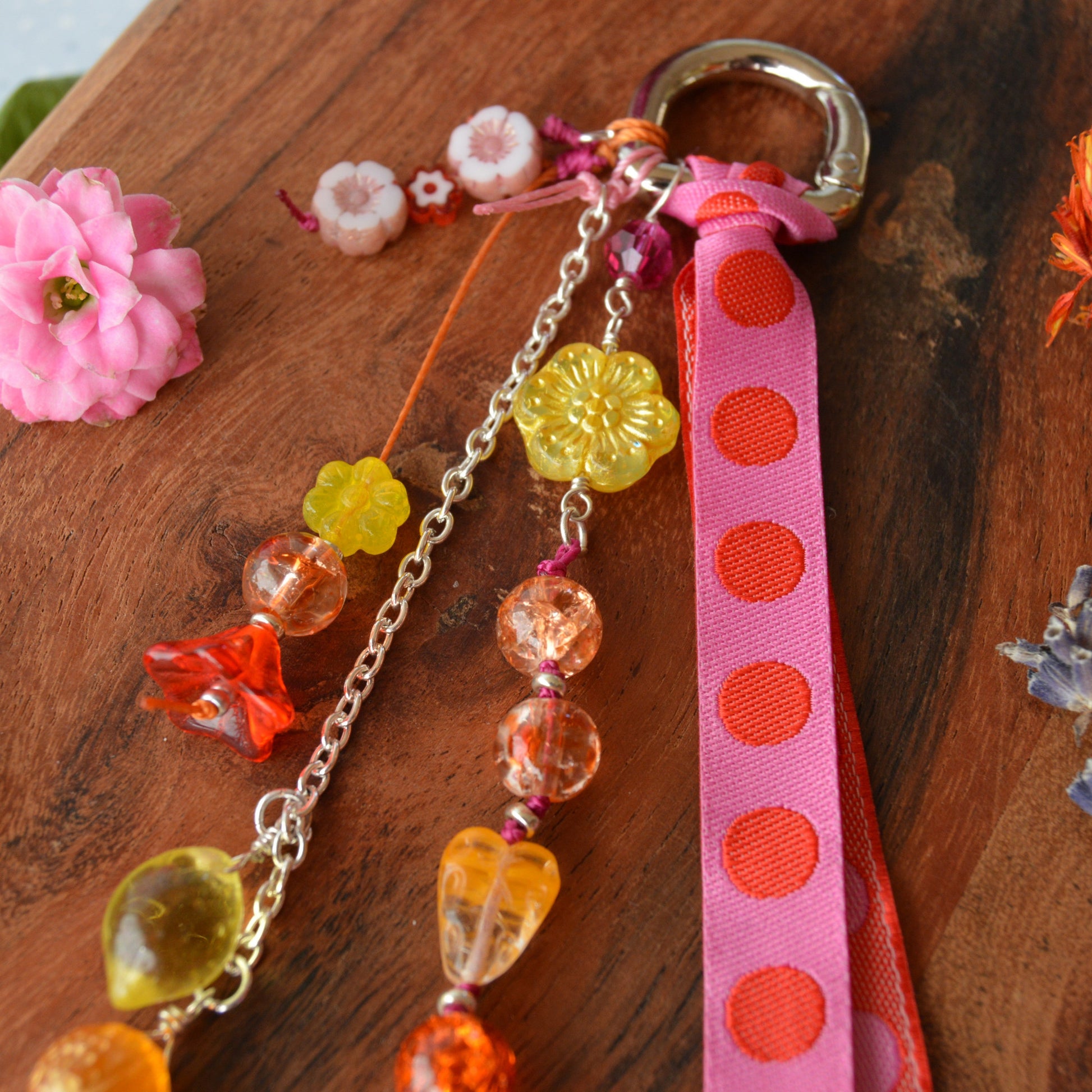 Handbag charm with Czech beads and ribbon in yellow, orange, pink, and red tones.
