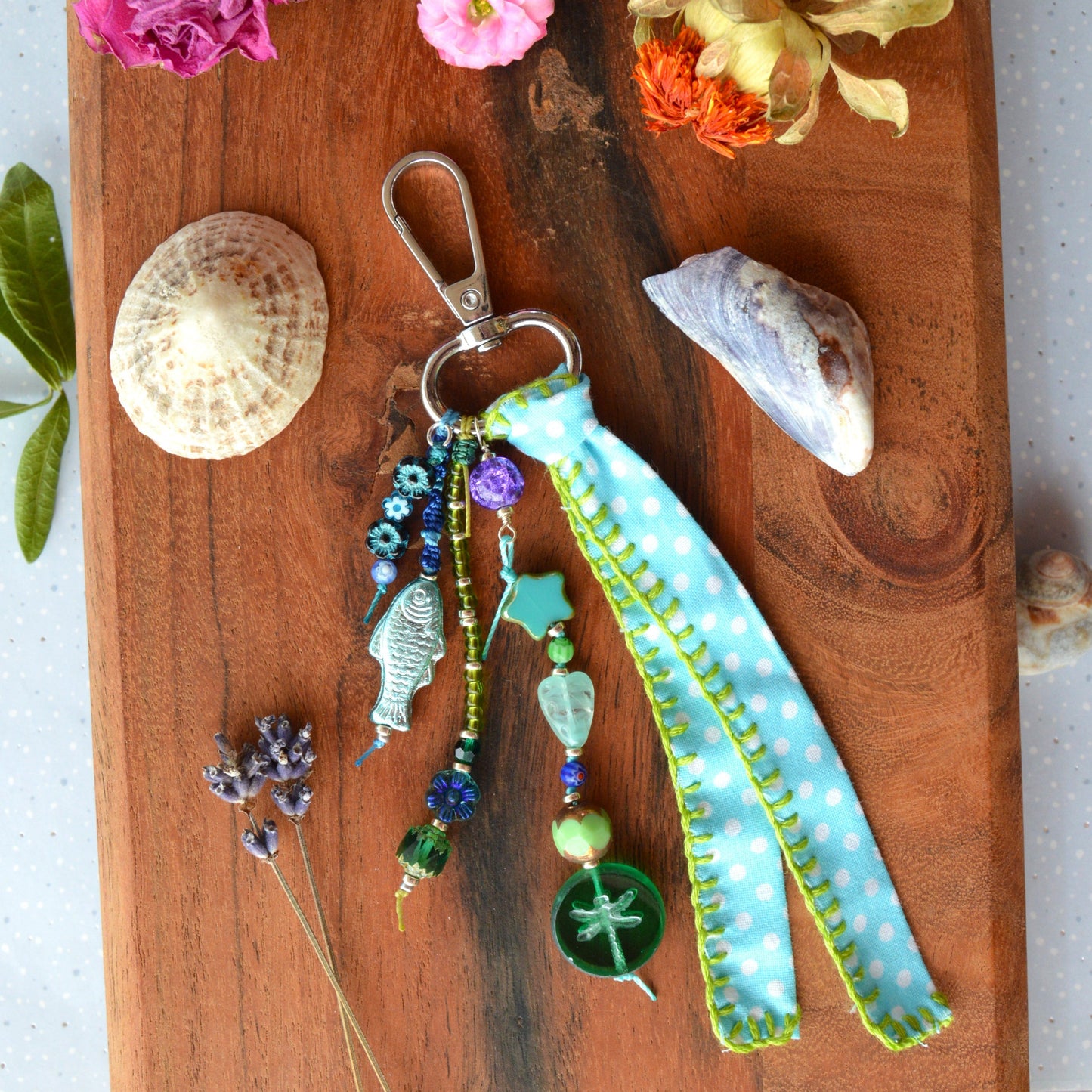 One of a kind colourful bag charm with a glass beads in blue and green tones.