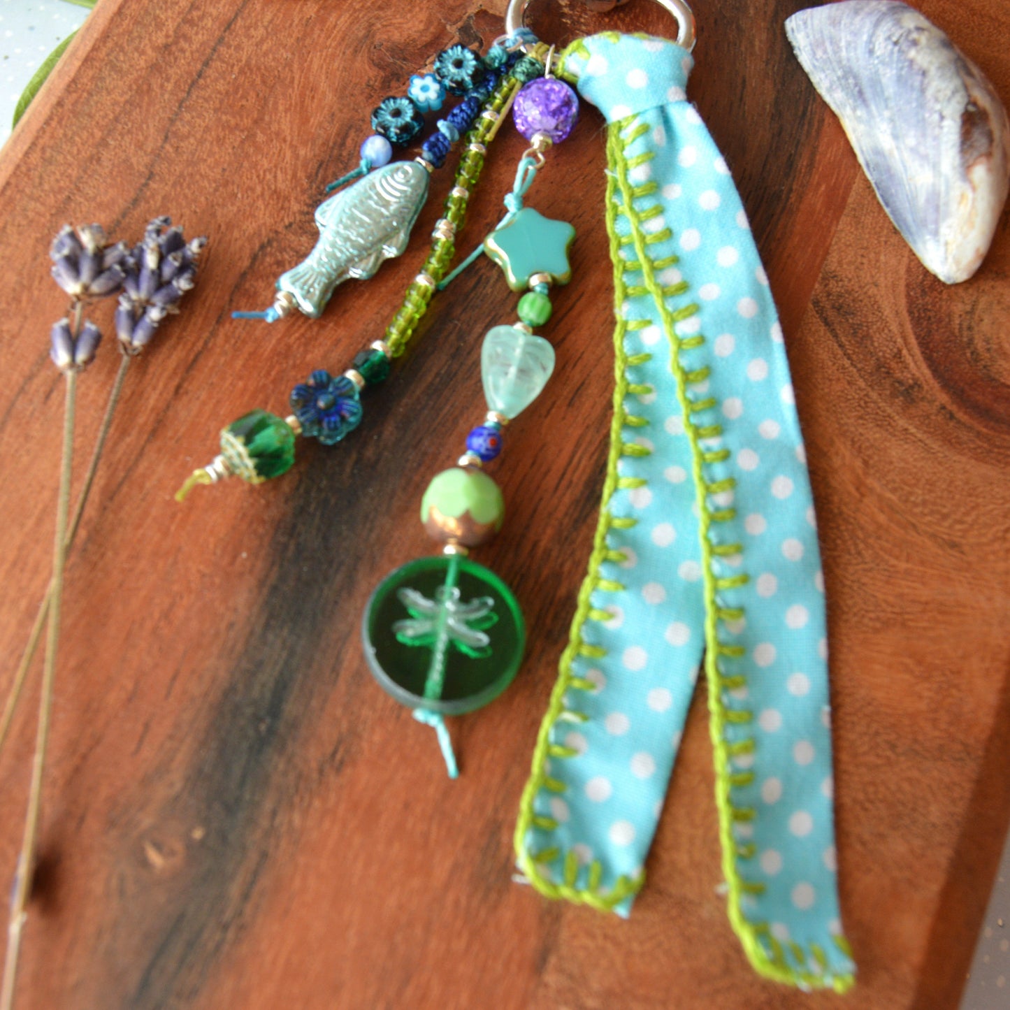 One of a kind colourful bag charm with a glass beads in blue and green tones.