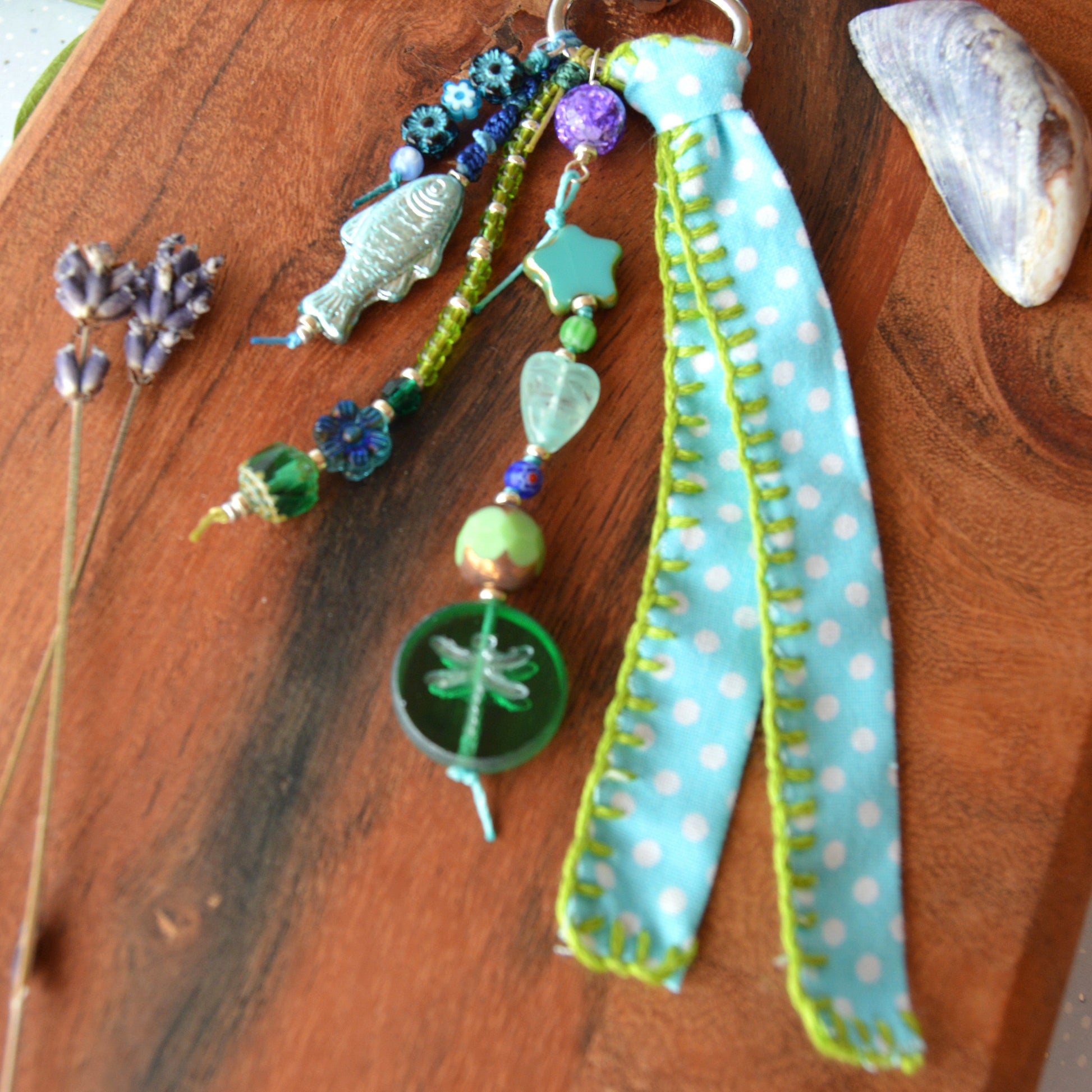 One of a kind colourful bag charm with a glass beads in blue and green tones.