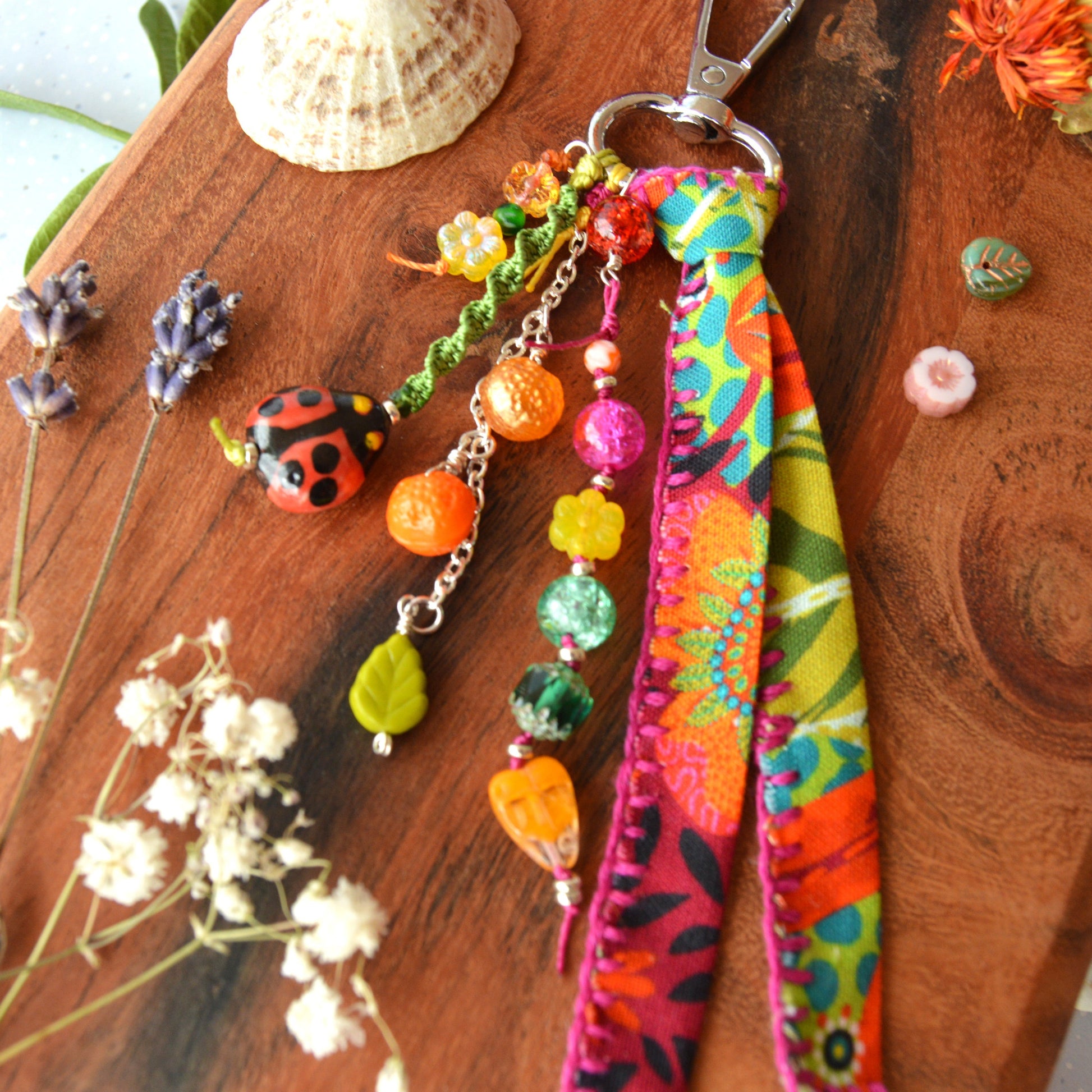 One of a kind colourful bag charm with ladybag, fruit- og flower glass beads.