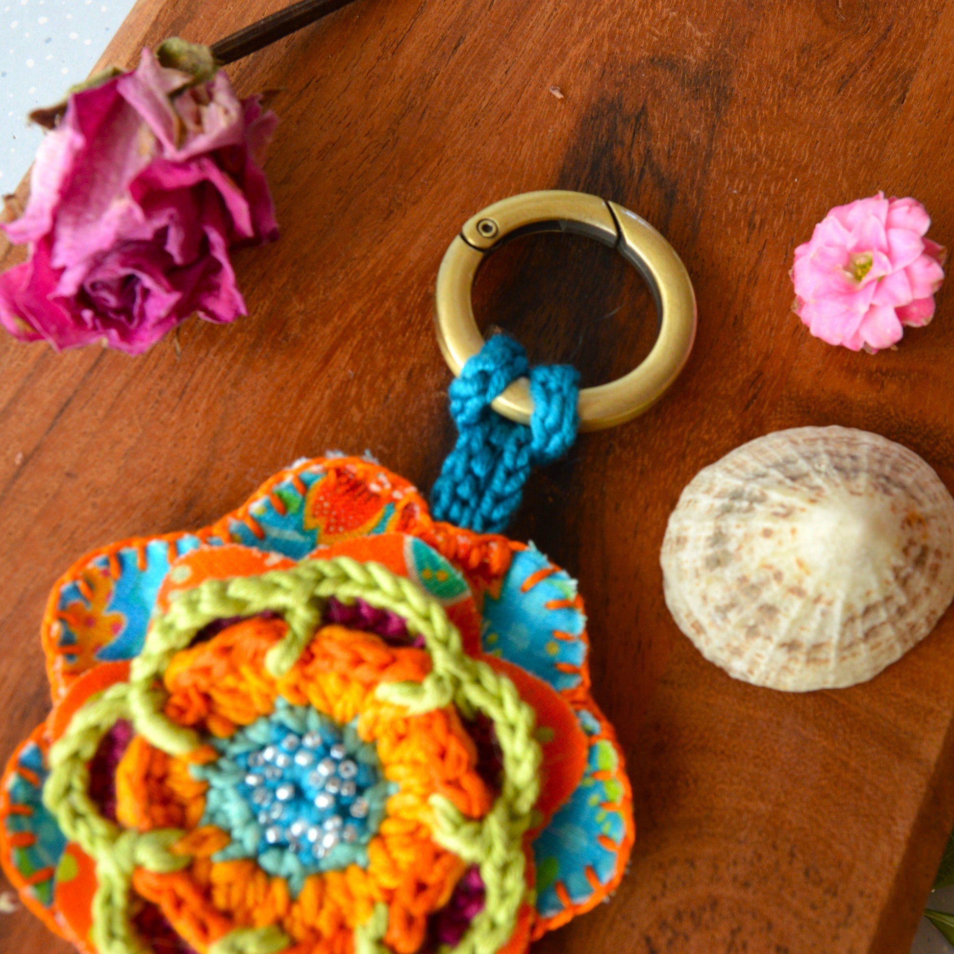 Handbag charm with crochet and fabric flowers decorated with seed beads.