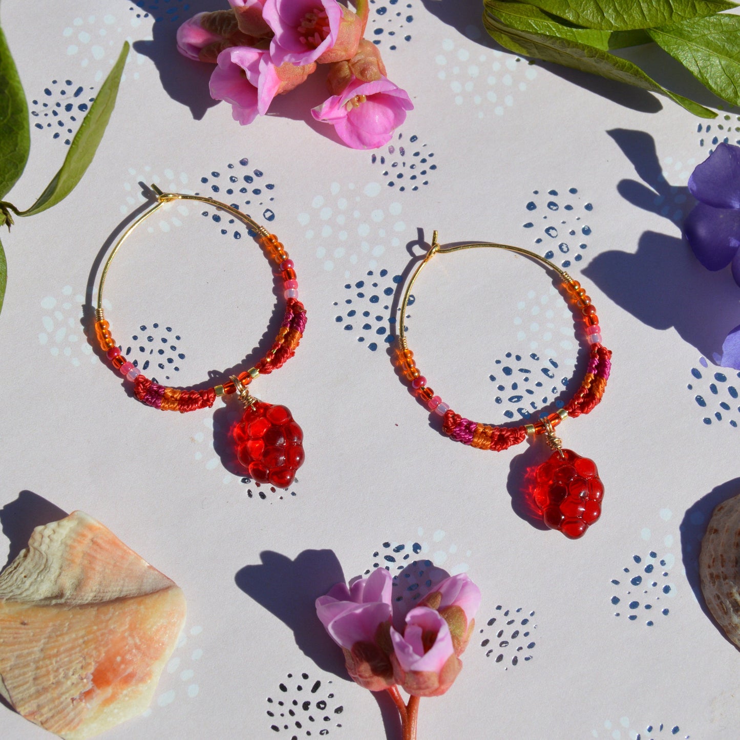 Colourful gold-plated sterling silver earrings decorated with micro macrame, Czech glass seed beads, and Czech glass grape fruit charm.