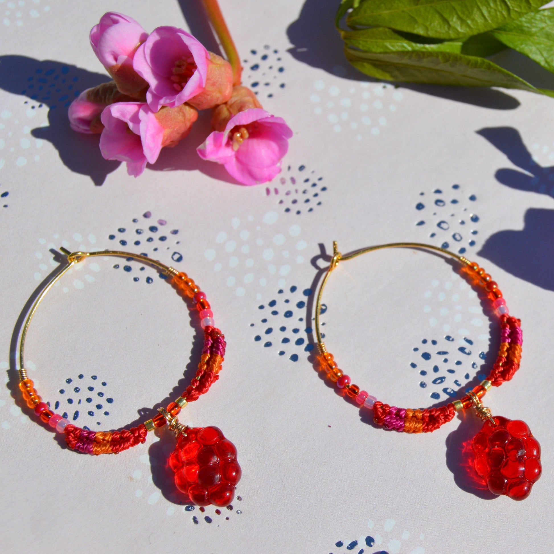 Colourful gold-plated sterling silver earrings decorated with micro macrame, Czech glass seed beads, and Czech glass grape fruit charm.