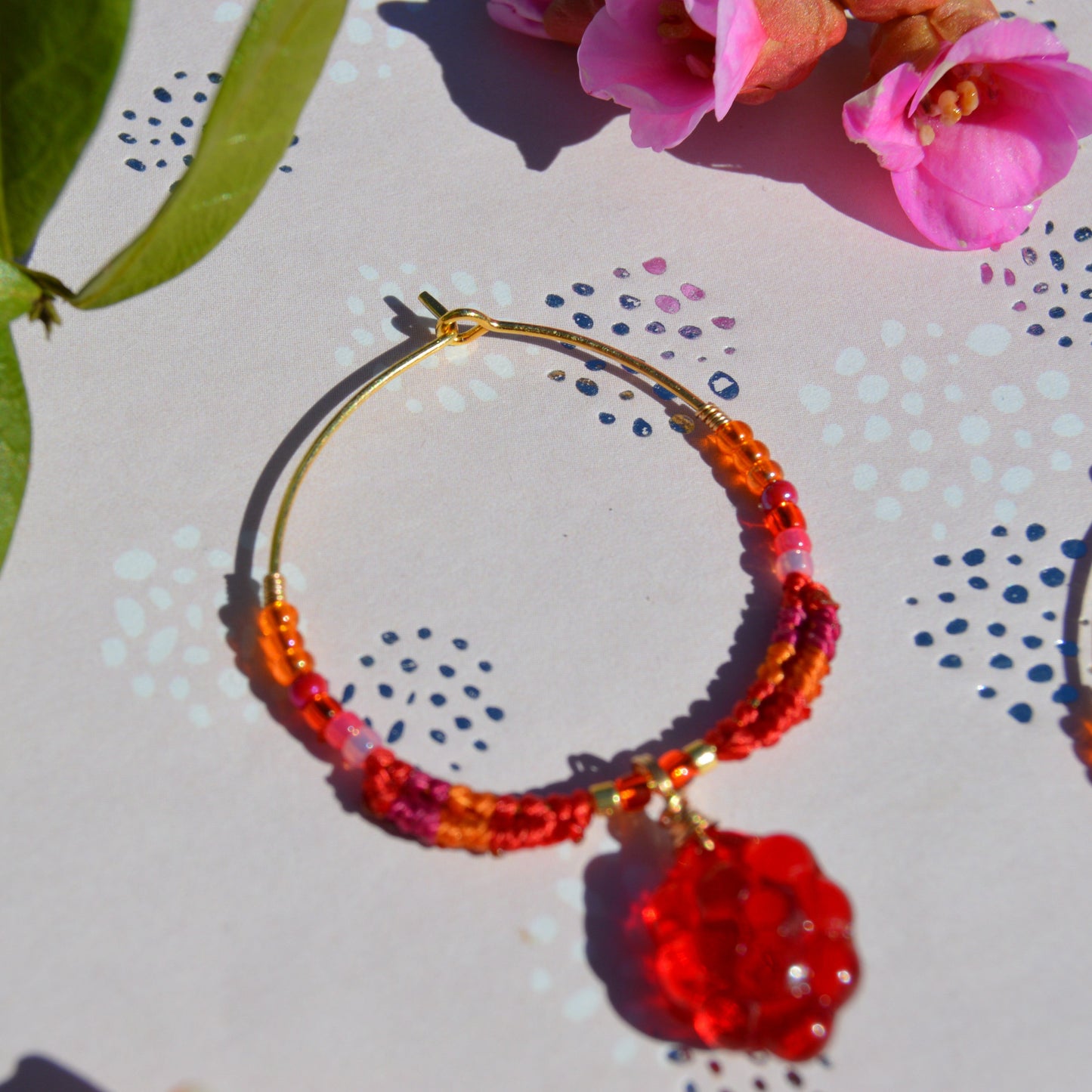 Colourful gold-plated sterling silver earrings decorated with micro macrame, Czech glass seed beads, and Czech glass grape fruit charm.