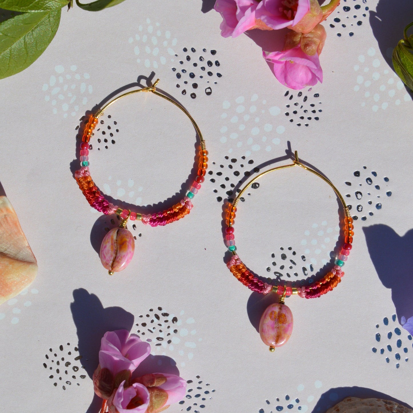 Colourful gold-plated sterling silver earrings decorated with micro macrame, Czech glass seed beads, and Czech glass coffee bean charm.