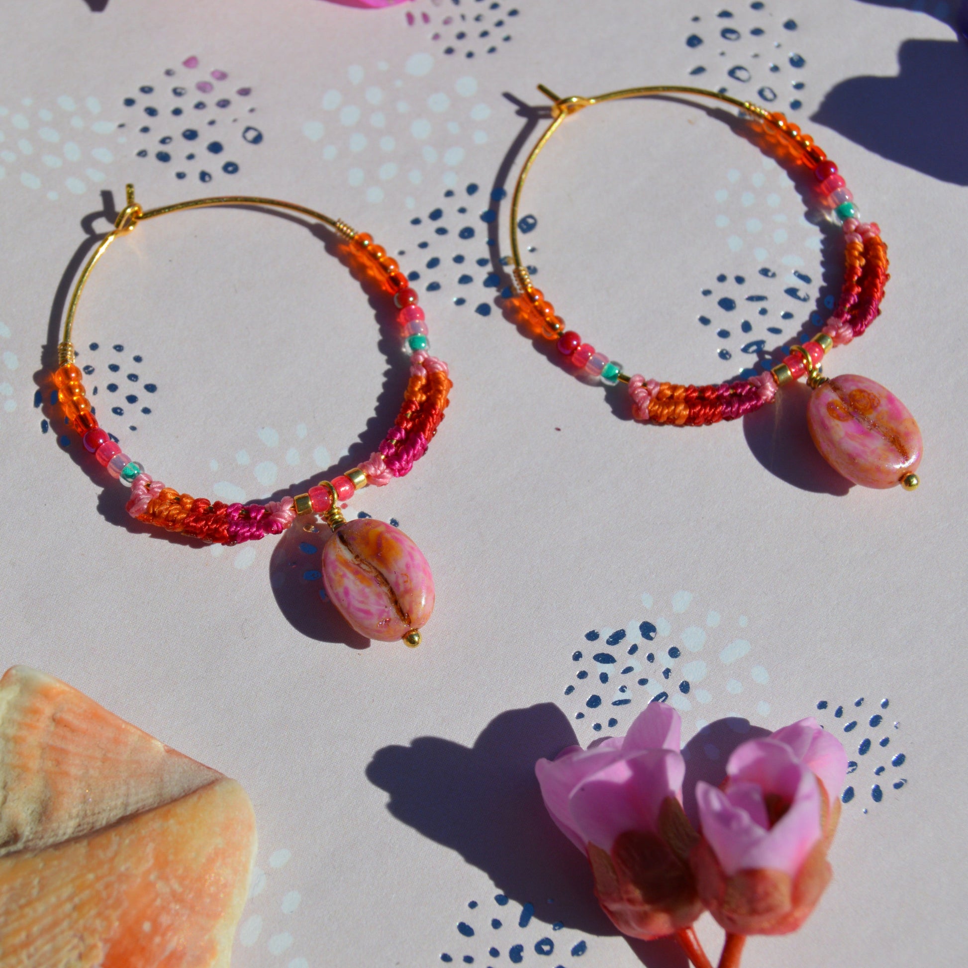 Colourful gold-plated sterling silver earrings decorated with micro macrame, Czech glass seed beads, and Czech glass coffee bean charm.