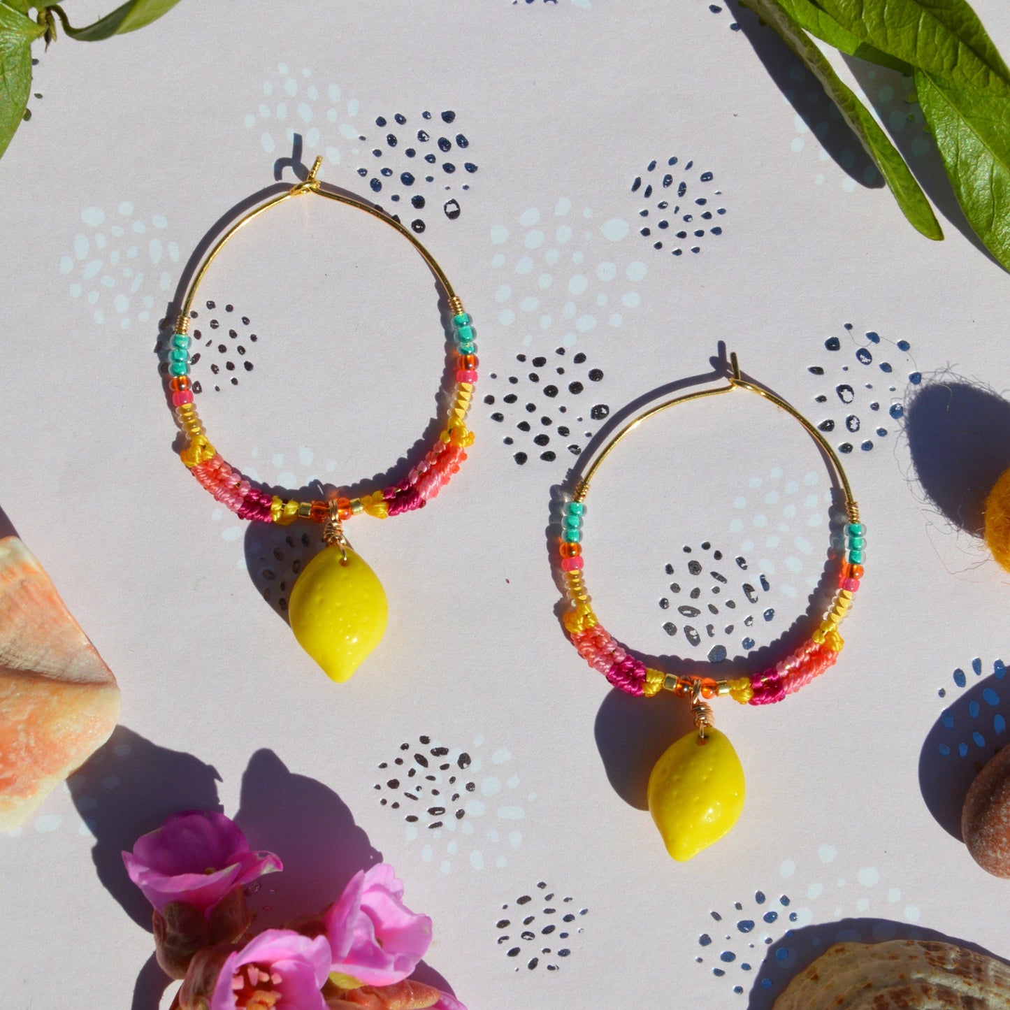 Colourful gold-plated sterling silver earrings decorated with micro macrame, Czech glass seed beads, and Czech glass lemon fruit charm.