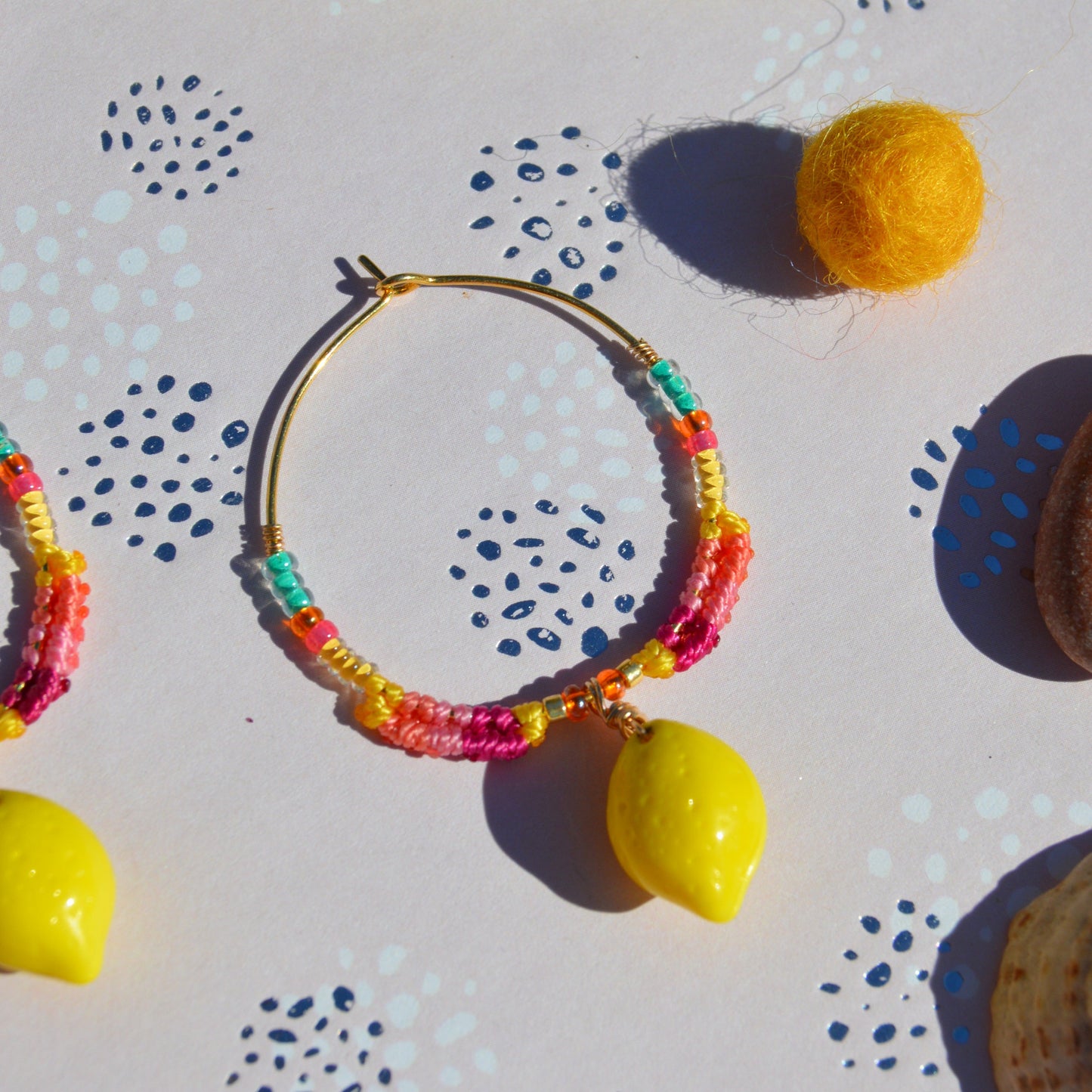 Colourful gold-plated sterling silver earrings decorated with micro macrame, Czech glass seed beads, and Czech glass lemon fruit charm.