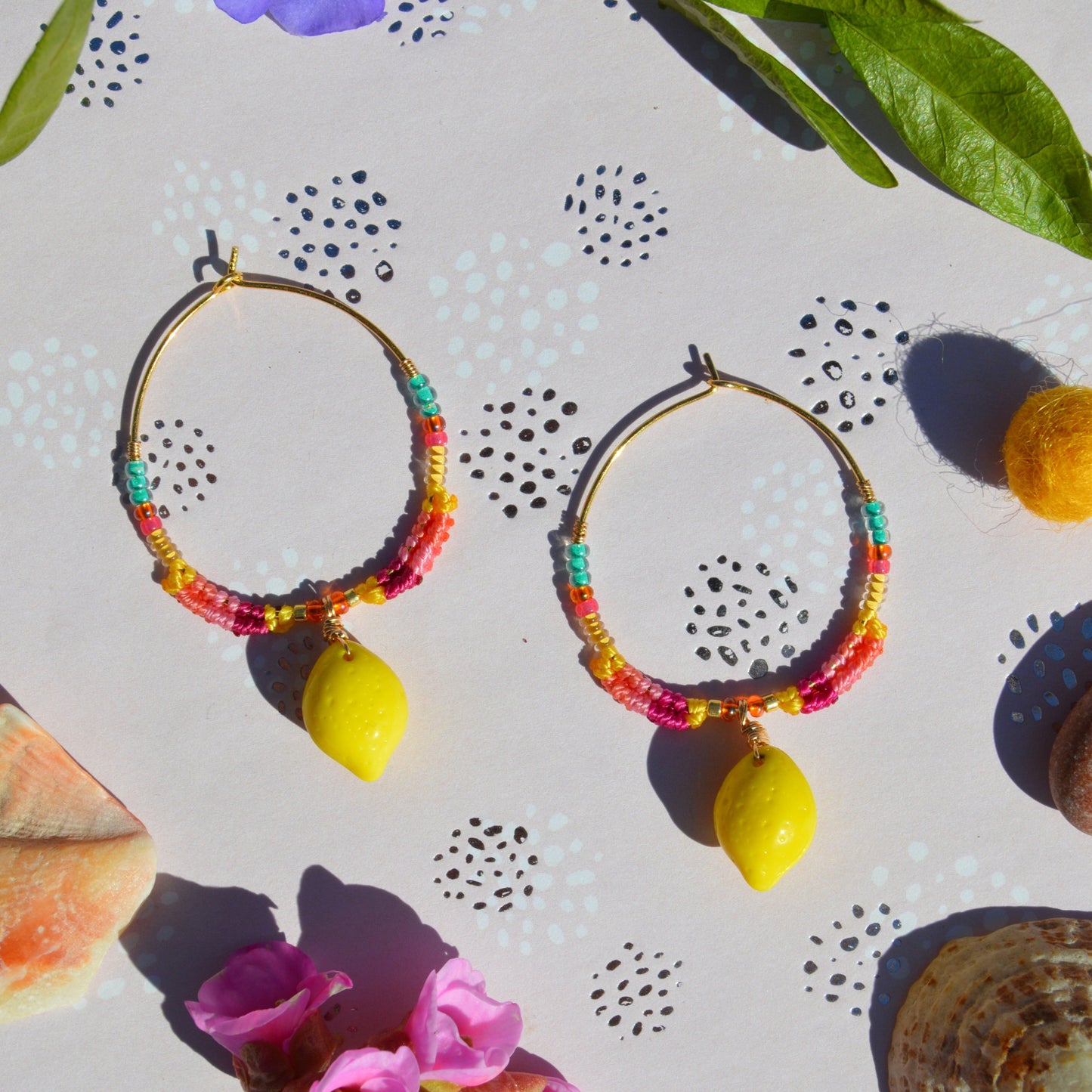 Colourful gold-plated sterling silver earrings decorated with micro macrame, Czech glass seed beads, and Czech glass lemon fruit charm.