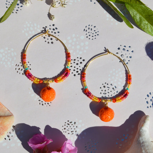 Colourful gold-plated sterling silver earrings decorated with micro macrame, Czech glass seed beads, and Czech glass orange fruit charm.