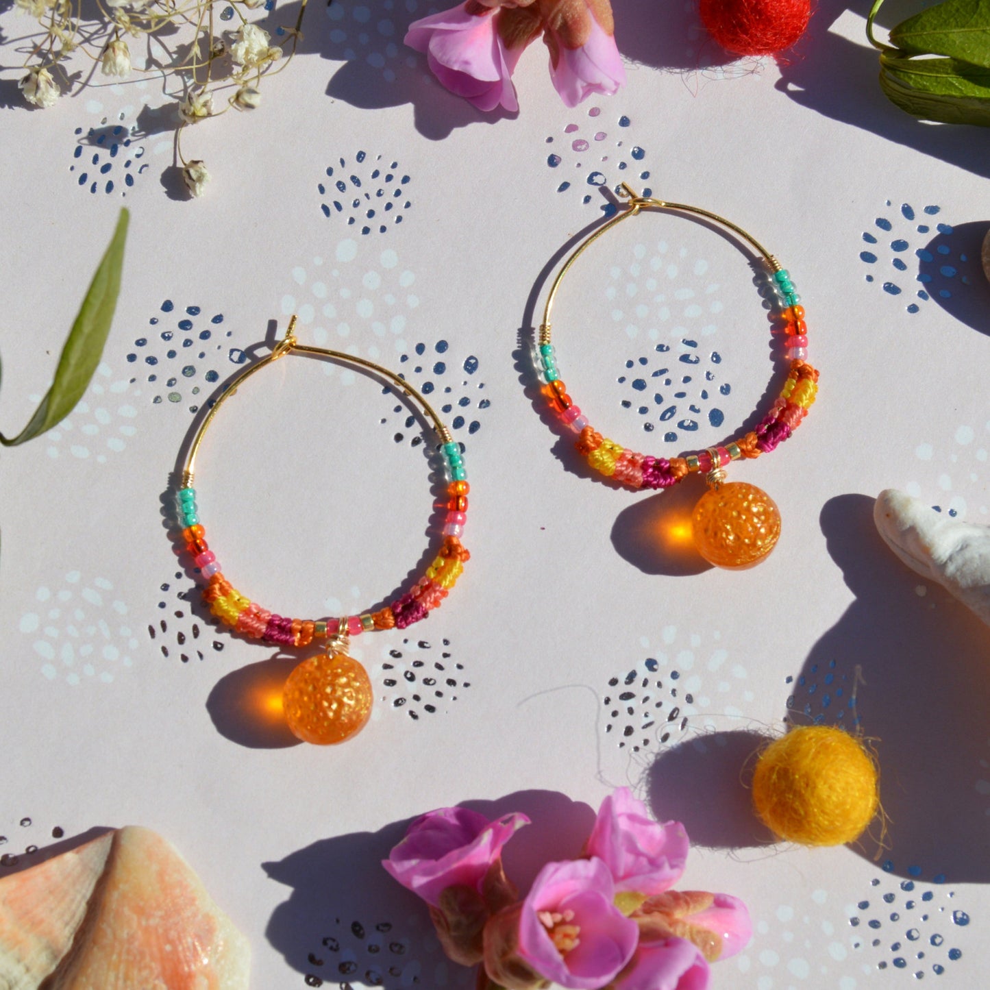 Colorful gold-plated sterling silver creoles decorated with micro macrame, Czech glass seed beads and Czech glass orange fruit bead in the center.
