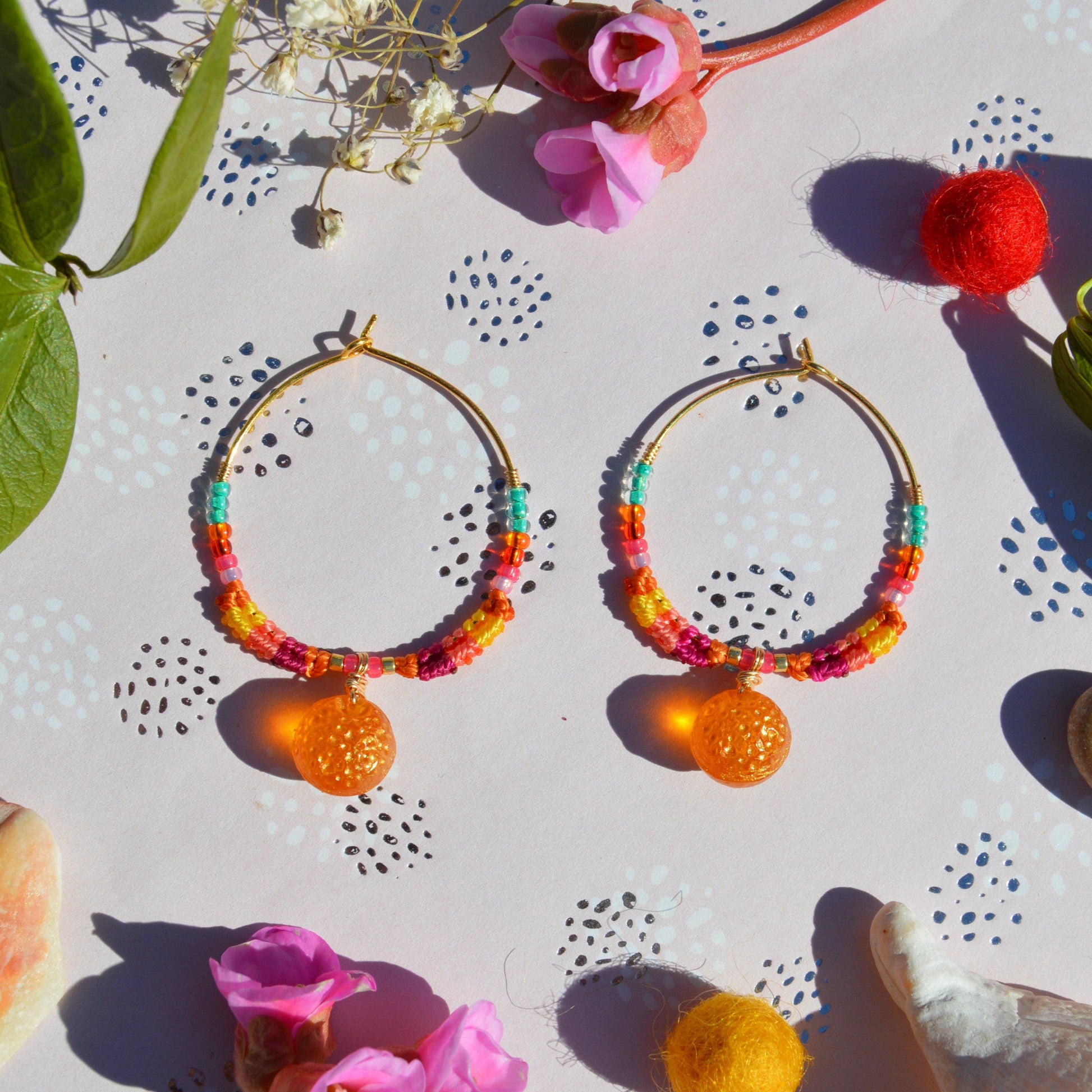 Colorful gold-plated sterling silver creoles decorated with micro macrame, Czech glass seed beads and Czech glass orange fruit bead in the center.