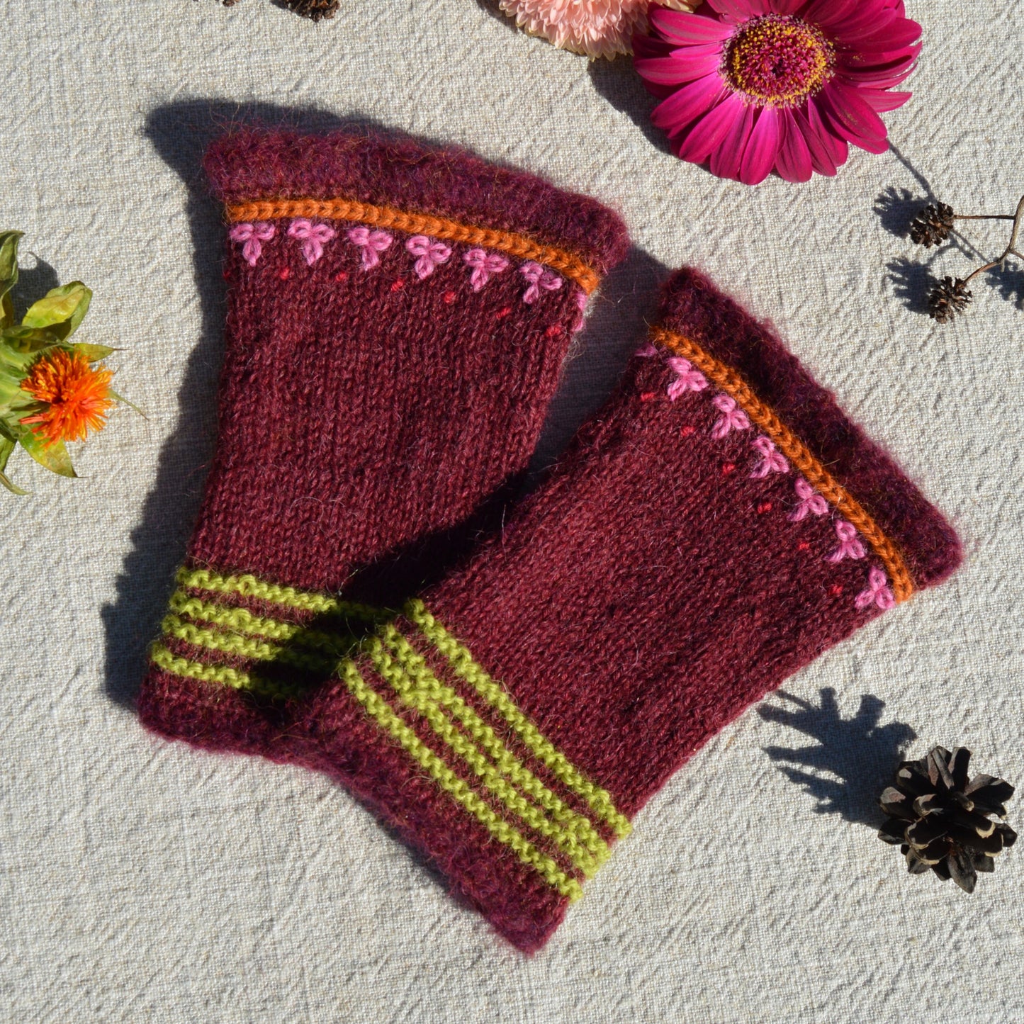 Knitted pulse warmers with crochet and embroidery details.