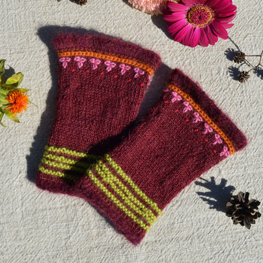 Knitted pulse warmers with crochet and embroidery details.