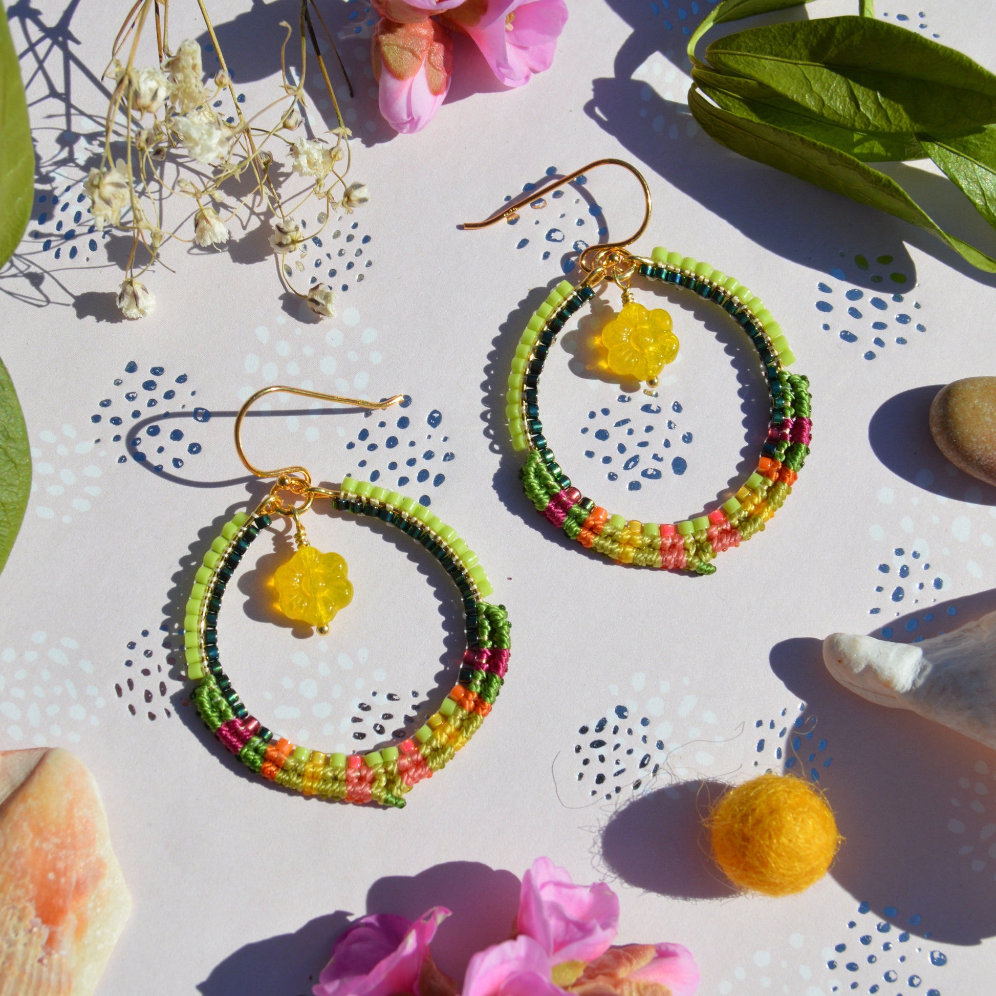 Colourful gold-plated sterling silver hoop earring decorated with micro macrame and woven Japanese seed beads. Czech glass flower charm.