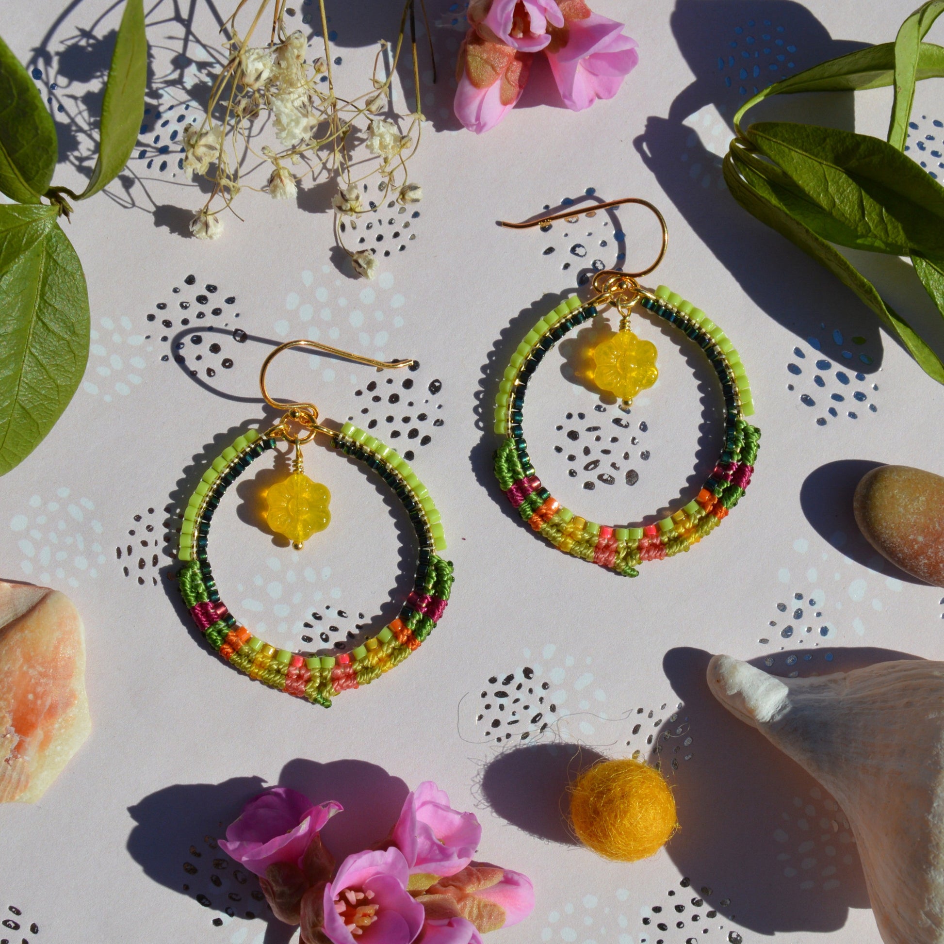 Colourful gold-plated sterling silver hoop earring decorated with micro macrame and woven Japanese seed beads. Czech glass flower charm.