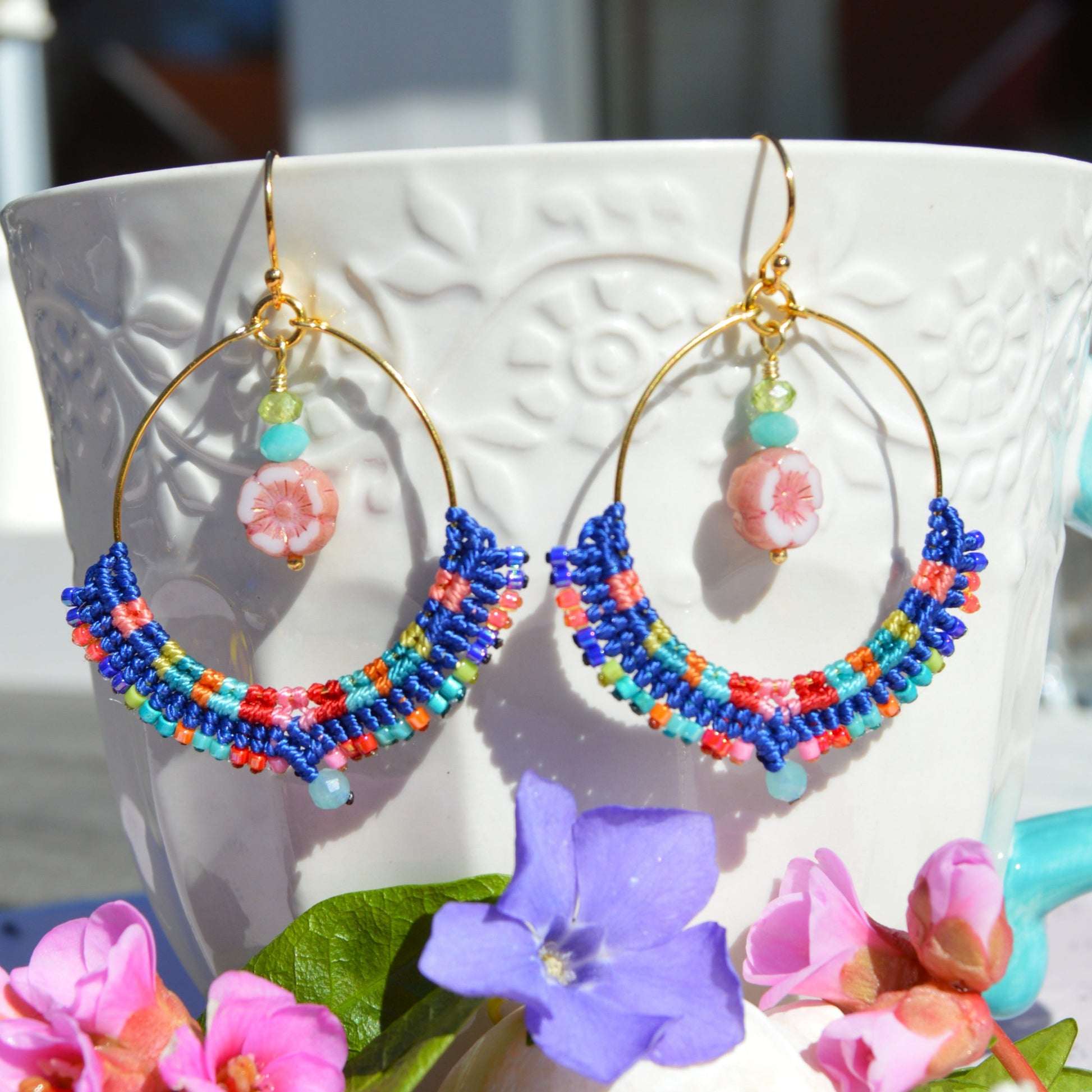 Colourful gold-plated sterling silver hoop earring decorated with micro macrame, Japanese seed beads, and amazonite gemstone. Czech glass flower charm with turquoise and olivine gemstones.