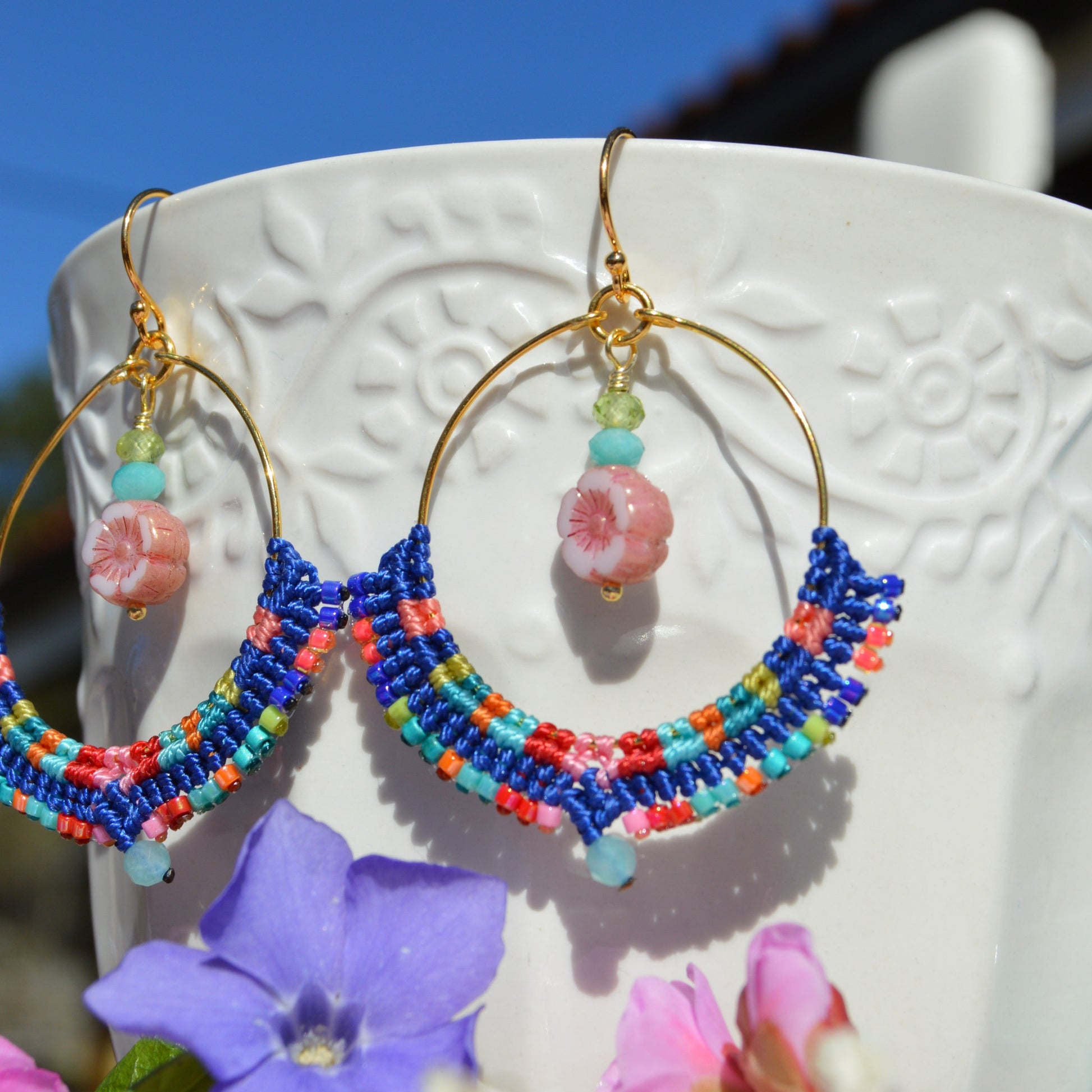 Colourful gold-plated sterling silver hoop earring decorated with micro macrame, Japanese seed beads, and amazonite gemstone. Czech glass flower charm with turquoise and olivine gemstones.