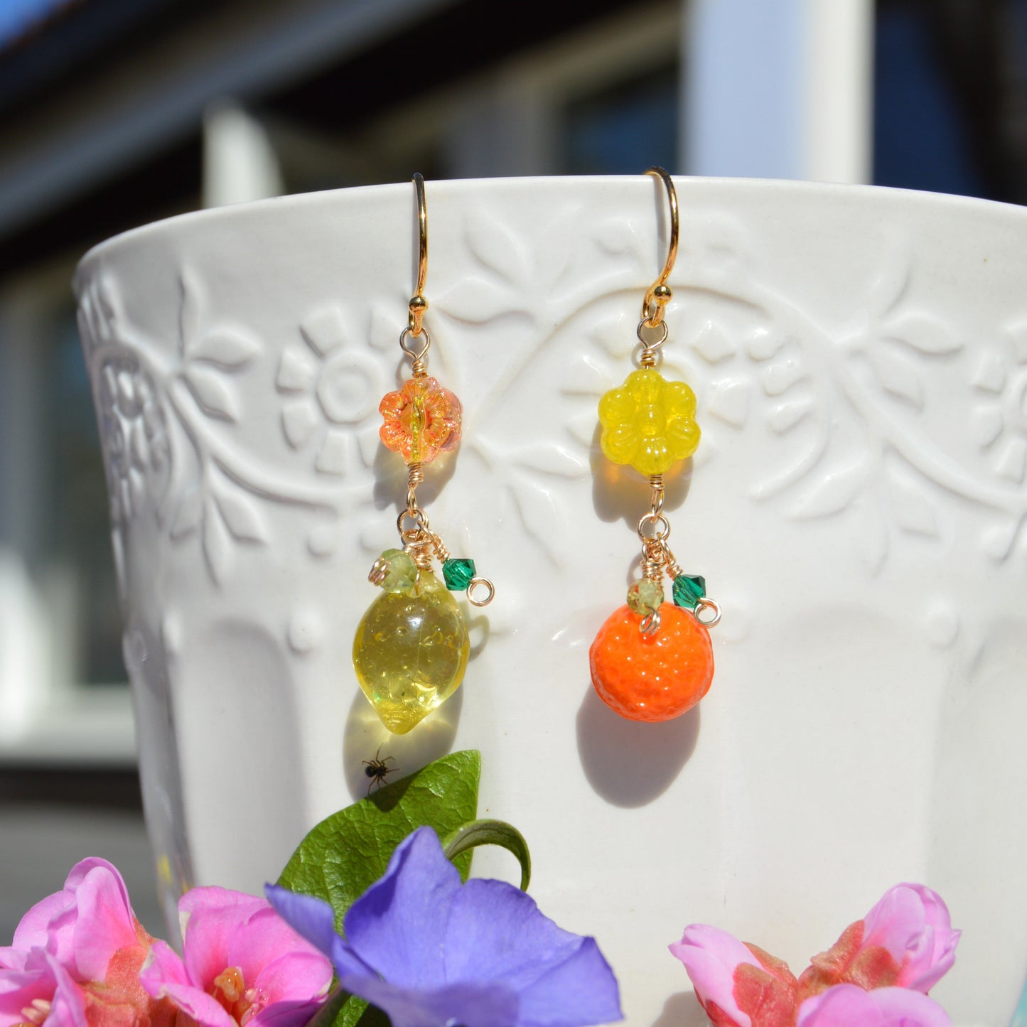 Gold-plated sterling silver earrings featuring Czech glass flower and fruit beads, faceted bicones, and olivine gemstone.