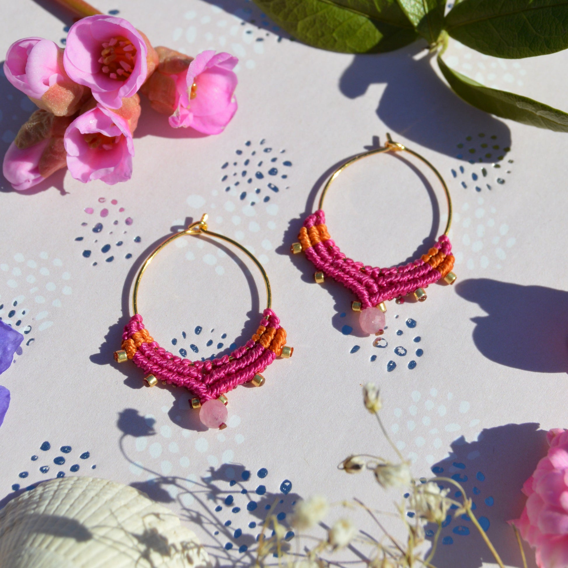 Small gold-plated sterling silver creole with macrame details in cerise pink & orange colour and a tourmaline gemstone.