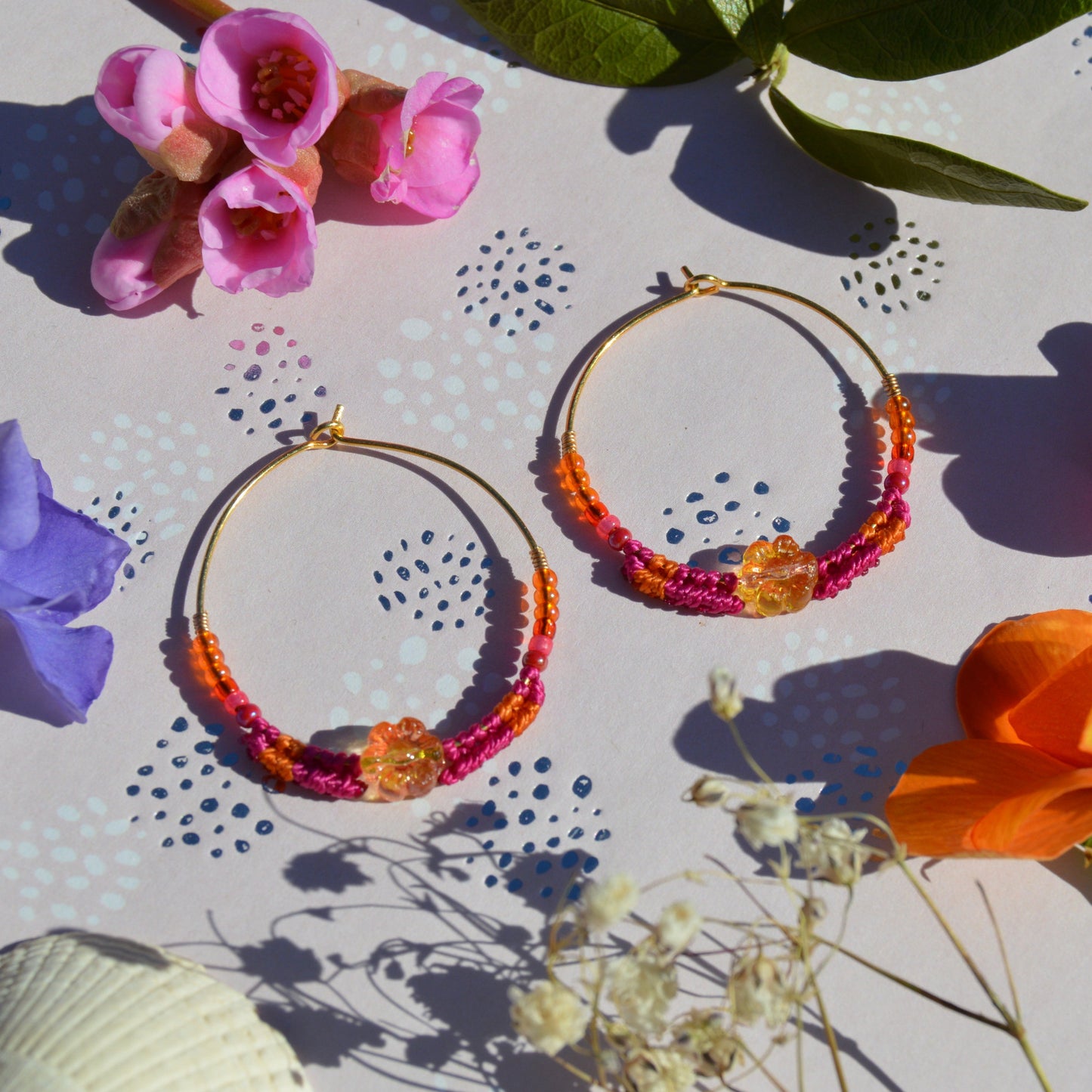 Colorful gold-plated sterling silver creoles decorated with micro macrame, Czech glass seed beads and Czech glass flower bead in the center.
