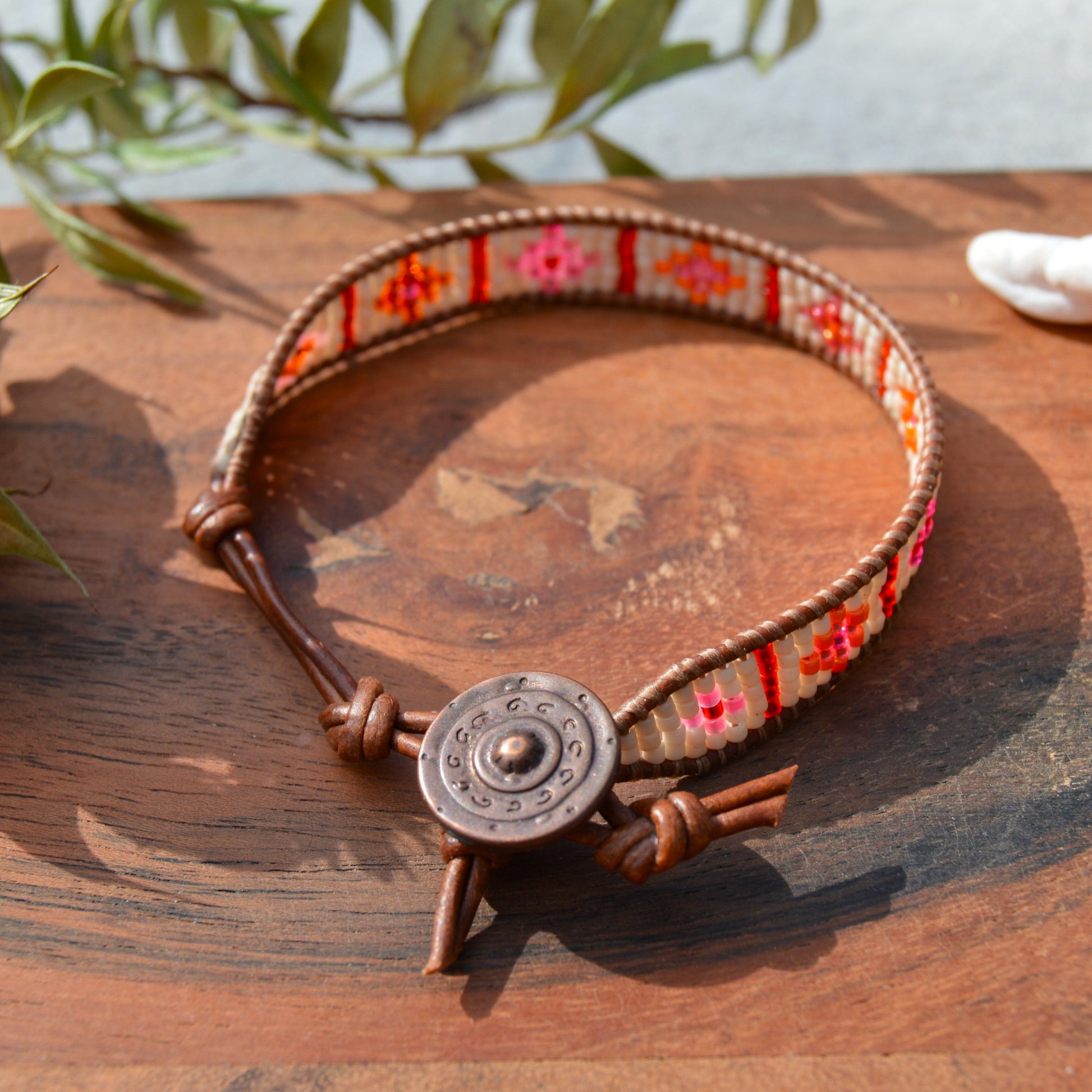 Boho leather wrap with woven Japanese seed beads and a button as a lock. Extension in leather.