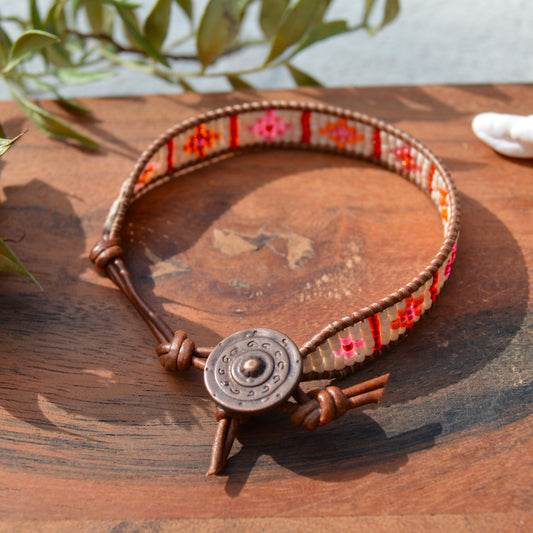 Boho leather wrap with woven Japanese seed beads and a button as a lock. Extension in leather.