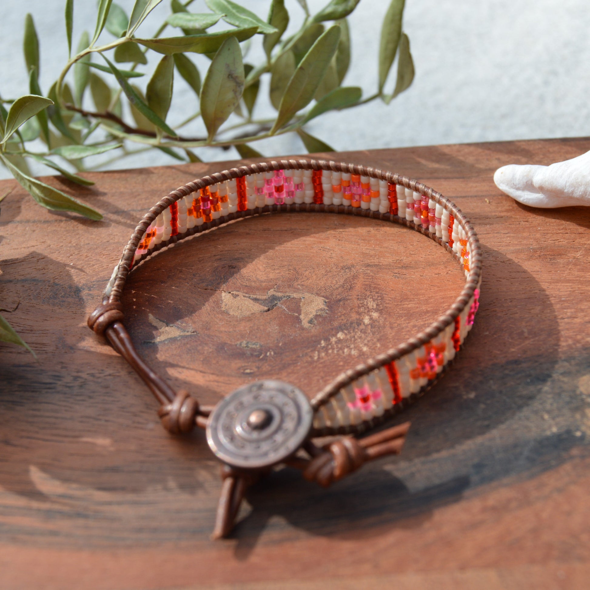 Boho leather wrap with woven Japanese seed beads and a button as a lock. Extension in leather.