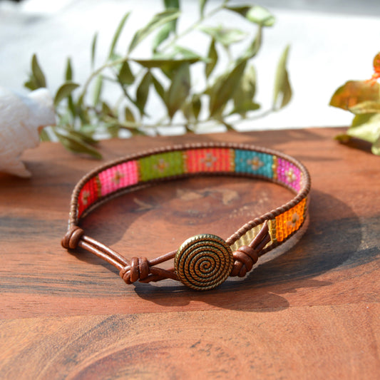 Boho leather wrap with woven Japanese seed beads and a button as a lock. Extension in leather.