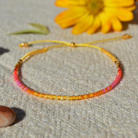 Adjustable seed beads bracelet Sunshine. Silicone stopper bead in gold-plated sterling silver.