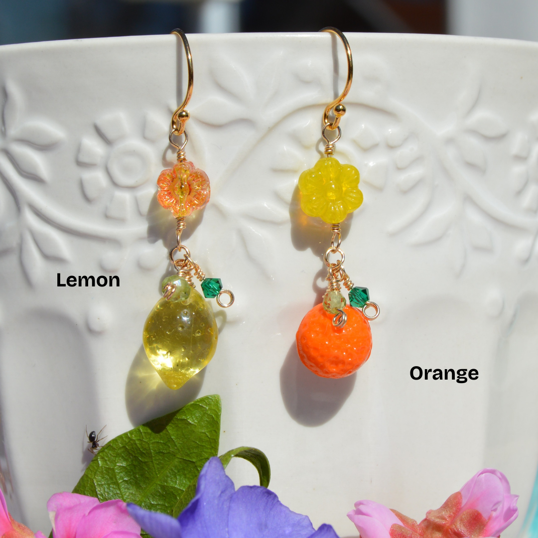 Gold-plated sterling silver earrings featuring Czech glass flower and fruit beads, faceted bicones, and olivine gemstone.