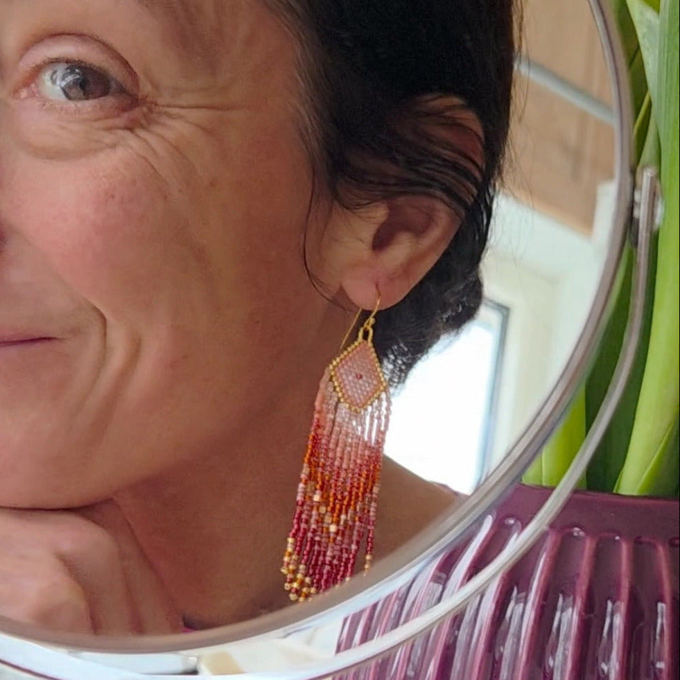 Dreaming Big long fringe earrings made of high quality Japanese seed beads in pink, dark orange, and shades of bordeaux colour combined with gold.